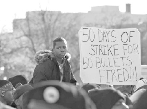 Protest sign: "50 days of strike for 50 bullets fired!!!"